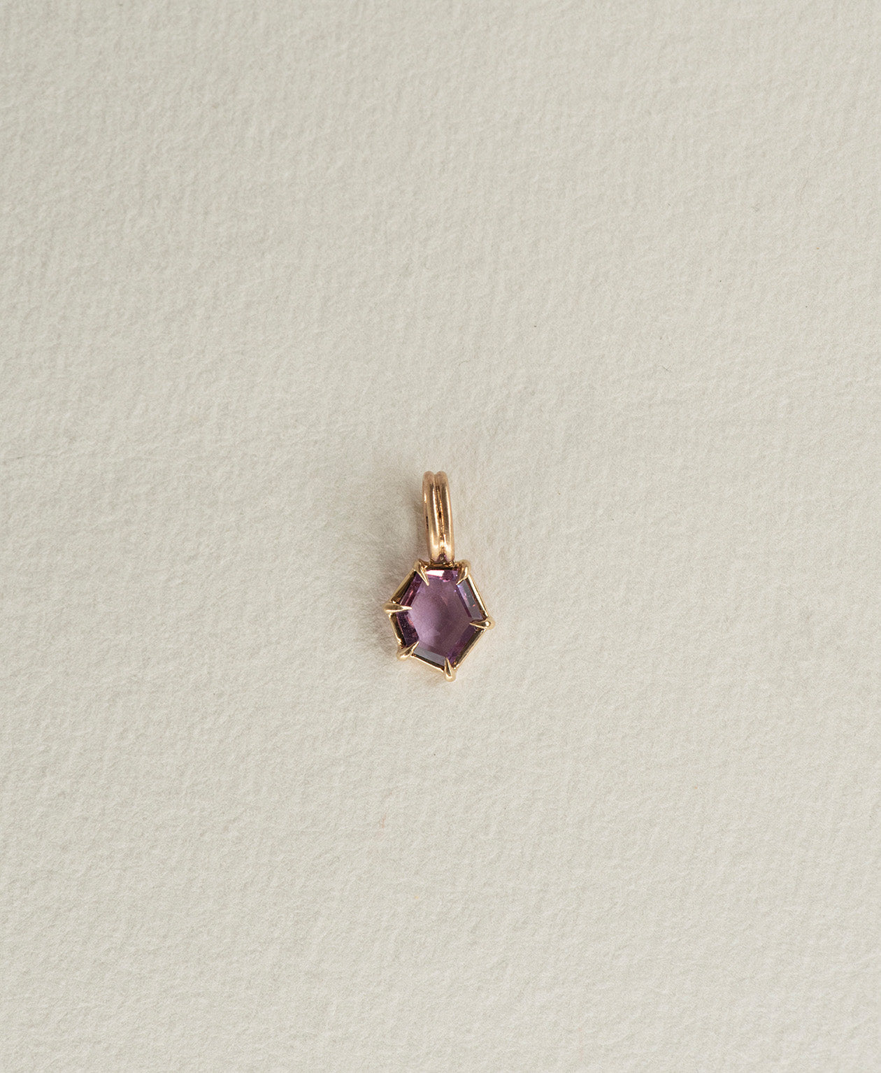 One of a Kind Charm 505 in 9k Yellow Gold featuring a deep purple hexagonal cut Sapphire with a claw setting.