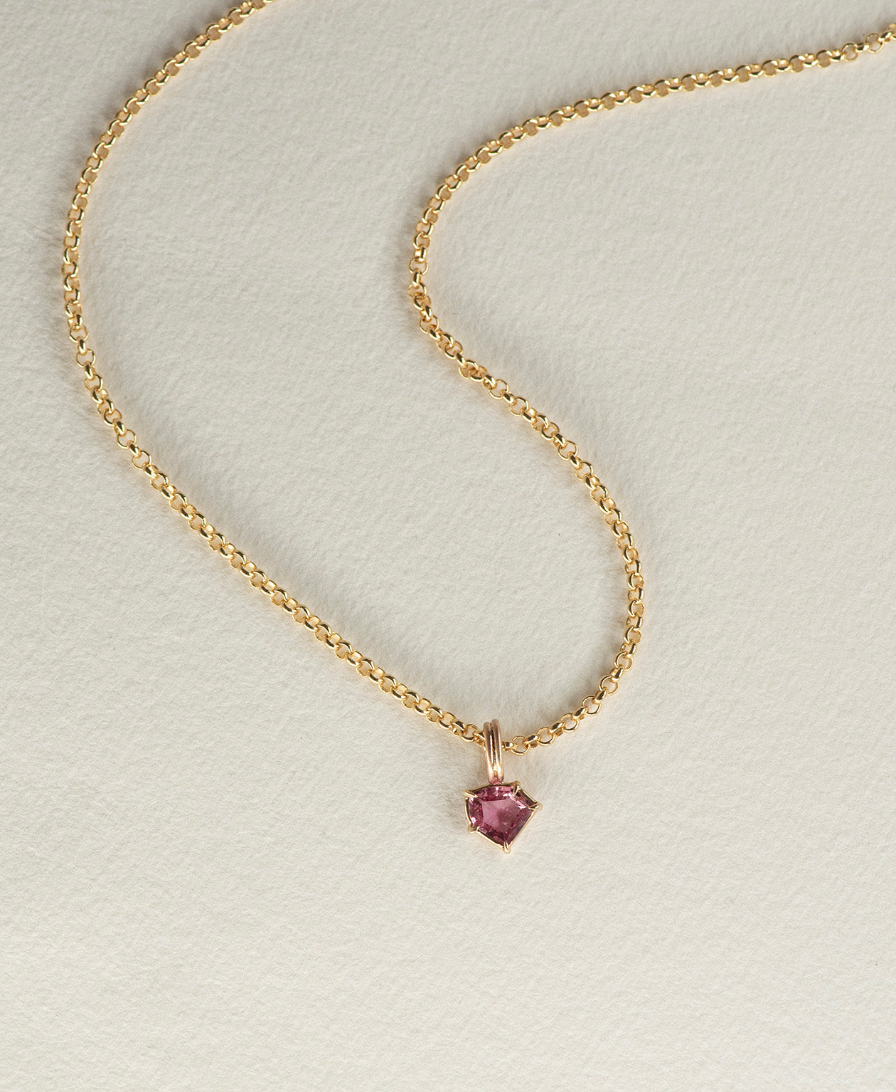 One of a Kind Charm 494 with a vibrant fuchsia pink portrait cut Sapphire on a belcher chain.