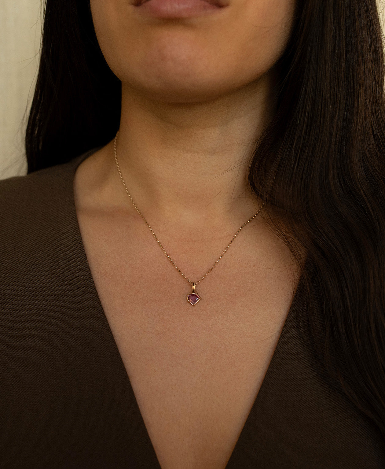 Close up of the One of a Kind Charm 494 with   vibrant fuchsia pink portrait cut Sapphire on a belcher chain.