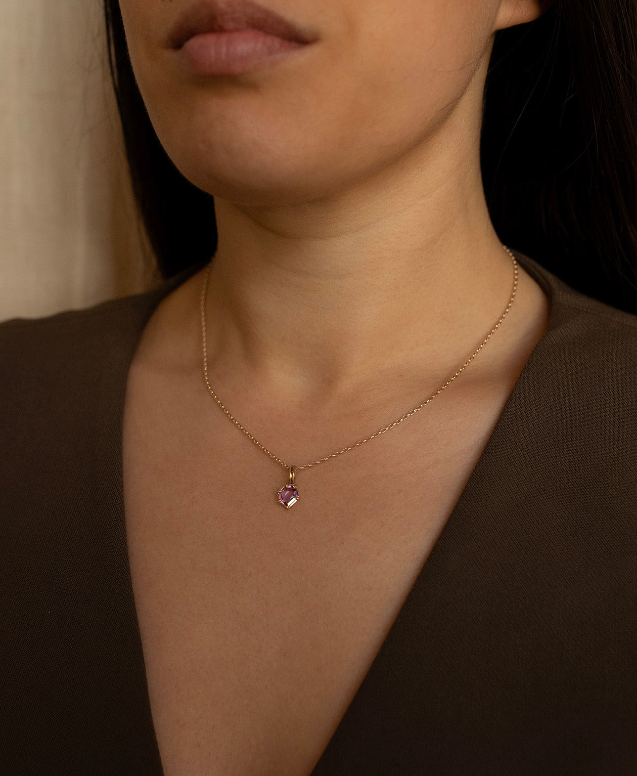 One of a Kind Charm 505 with a deep purple hexagonal cut Sapphire worn by a model on a fine belcher chain.