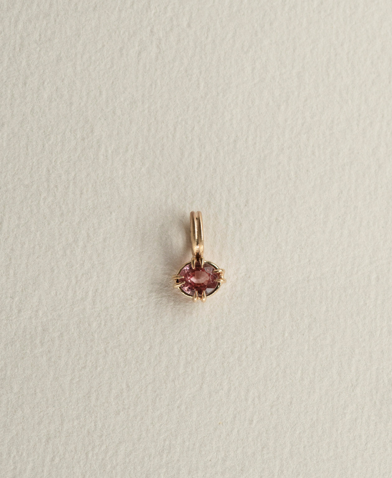 One of a Kind Charm 520 in 9k Yellow Gold featuring a pink oval cut Garnet with a claw setting.
