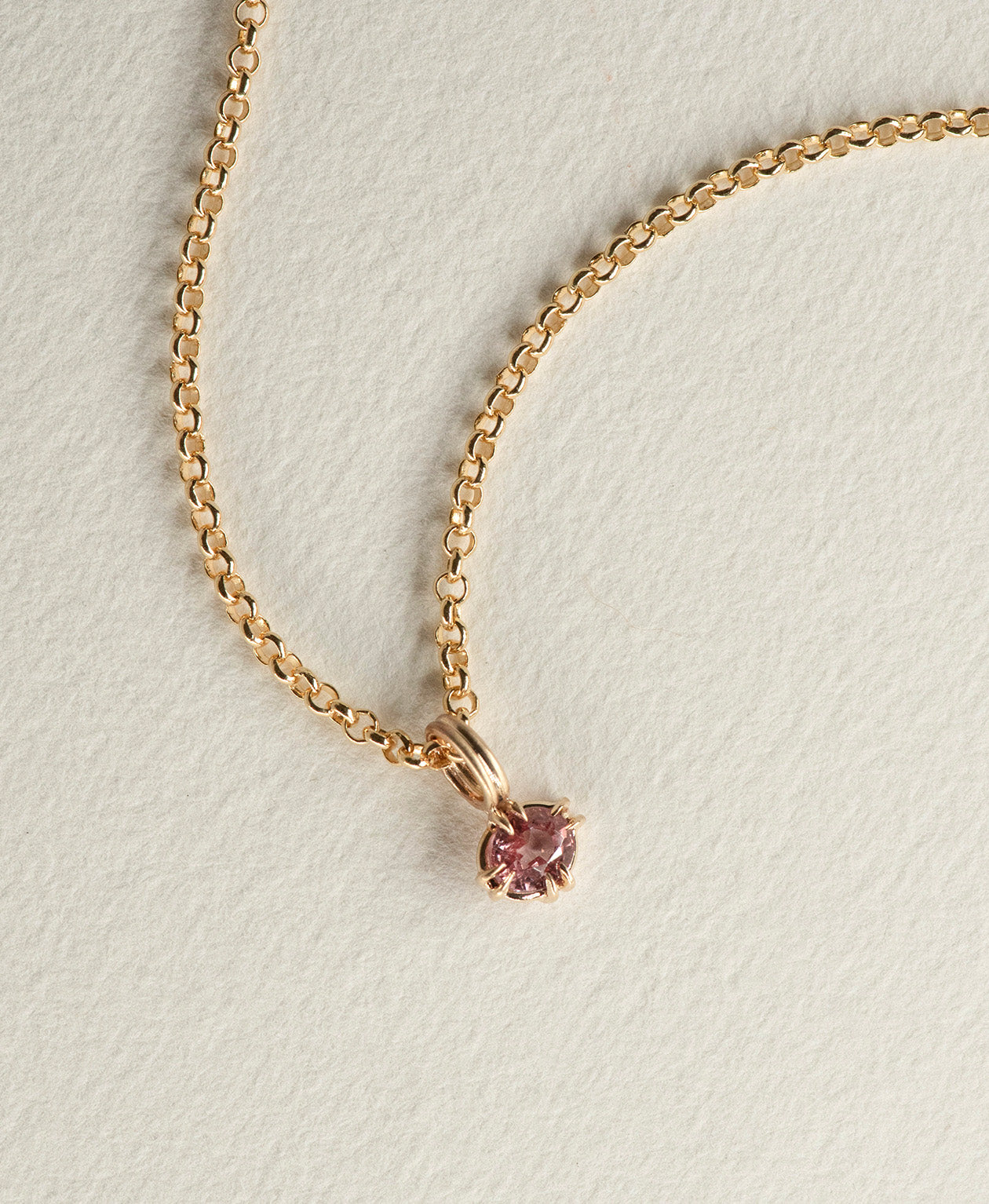 Close up of the One of a Kind Charm 520 with a pink oval cut Garnet on a belcher chain.