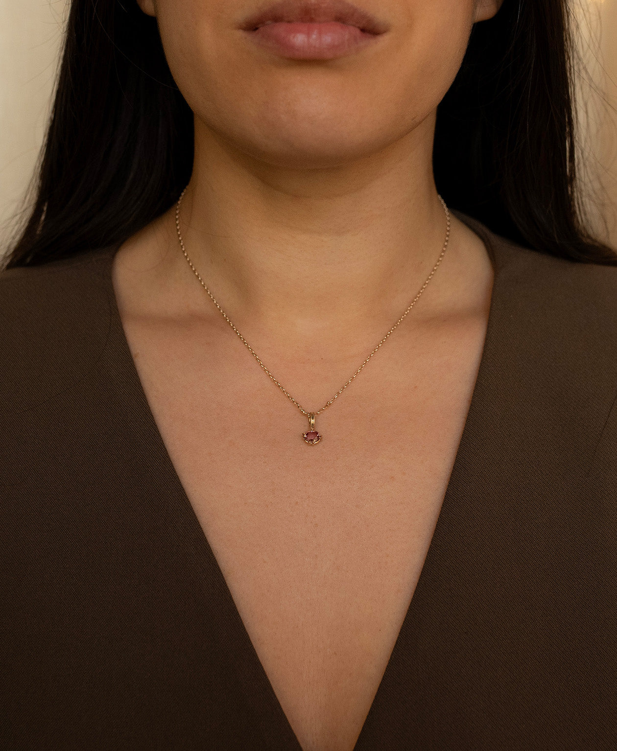 One of a Kind Charm 520 with a pink oval cut Garnet worn by a model on a fine belcher chain. 